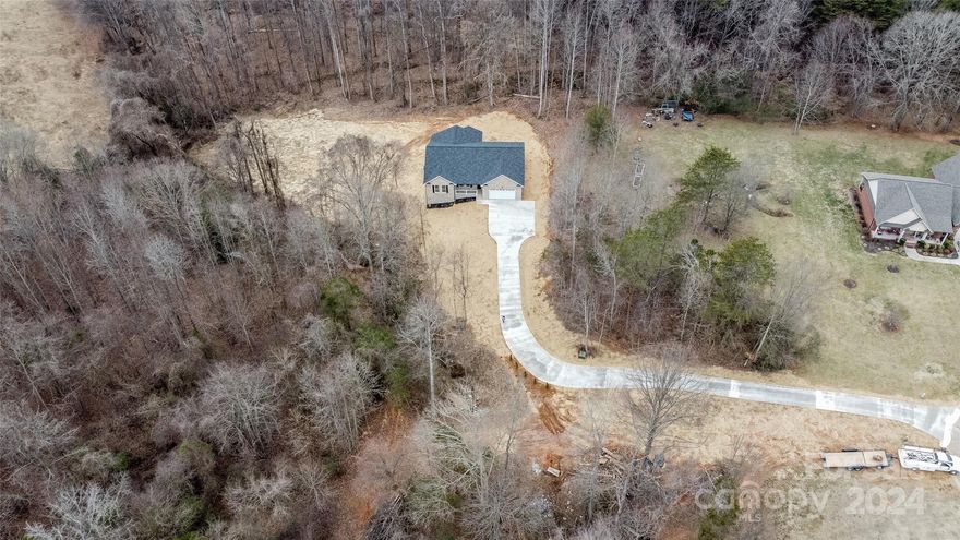 Welcome to your dream home! This newly constructed, full brick residence is a perfect blend of modern luxury and classic charm. Situated on a private, almost 2-acre lot, this property offers the perfect combination of tranquility and convenience. Boasting 3 BR & 2.5 BA, this spacious home provides ample room. The long 320+ ft concrete driveway leads to a private homesite. Beautiful LVP flooring throughout. The heart of the house is the stunning open kitchen, equipped with a large granite kitchen island, stainless steel appliances, and pantry. The open vaulted ceiling in the main living area adds an airy and spacious feel, creating a welcoming atmosphere for gatherings and relaxation. Covered deck off the rear of the home, provides a perfect spot for relaxation. This property is a true haven for those seeking a modern, stylish, and private retreat within the comforts of a well-established neighborhood. Don't miss the opportunity to make this house your home!