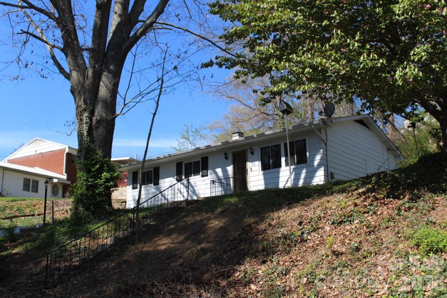 A West Asheville Gem - Located just off of HWY 240, Prime Location, just a few minutes drive to downtown Asheville or to The Biltmore!!  A Diamond in the Rough as they say - Home has good bones, all hard wood floors on the main level, a newly finished basement with heat/ air & a laundry room.  Home features a gas tankless water heater, gas furnace, 3 Bedrooms and 1 bath.  Home has a 1 car garage, a nice backyard with privacy wall, perfect for a small garden, a firepit for chilly winter nights.  Home needs some cosmetic finishes to make it your own - Bring your palate, your vision, your dream - Maybe this home is what you have been waiting for!!