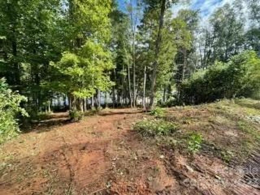 RARE OPPORTUNITY to buy a dockable waterfront lot with the possibility of having a beach area on Lake Rhodiss. This beautiful and private community offers close proximity to Hickory and Morganton with low HOA dues. Even better, this lot is mostly cleared already, has great views, a large amount of waterfront, and hookups to city water and sewer! The seller has recently completed all the heavy lifting to obtain the dock permits from Duke and can provide them. Duke is allowing a 1000 sqft dock on this site!