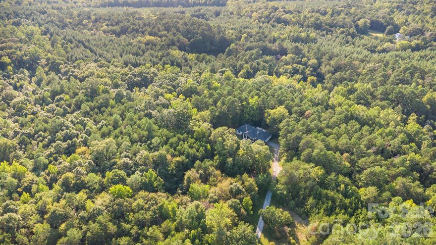 Spanning nearly 25 acres just beyond the city limits, this exceptional property is perfect for a custom home build site, offering a rare opportunity to own a large, versatile tract of land in a highly convenient location. The expansive acreage provides ample space for a wide range of uses, including equestrian activities, recreational enjoyment, or future development. With its scenic surroundings and open landscape, the property is well-suited for a private estate, family compound, wedding or event venue, or income-producing ventures such as short-term rentals or tiny home development. The property has passed perc testing in several additional areas, adding valuable flexibility for future building opportunities. Despite the sense of privacy and seclusion, the property is located less than 10 minutes from downtown Concord and Kannapolis, with easy access to I-85. A custom-built brick home is situated on the property, allowing buyers to enjoy an existing residence while planning future possibilities. Offering flexibility, space, and location, this property presents a unique opportunity for builders, investors, or buyers seeking room to grow.