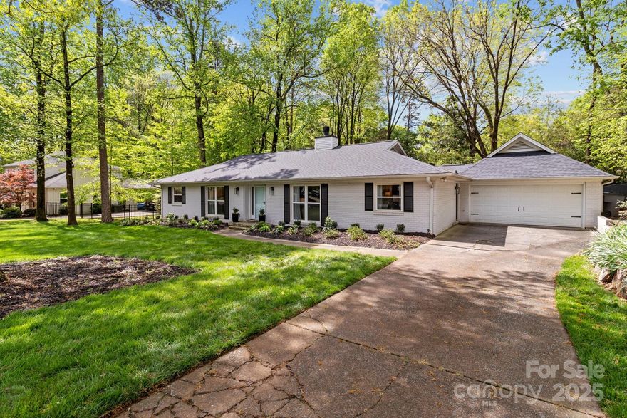 MOVE IN. UNPACK. ENJOY. This stunning white brick ranch in sought after Stonehaven is ready for its new owners. With a brand new roof ('25), tankless water heater ('25), windows ('20, sunroom '14), remodeled primary & hall baths ('21, '24) and newer HVAC ('19) all the big ticket items have been done for you. Hardwood floors and tile throughout. Freshly painted. Bright & airy open floor plan with a beautiful see-through stone fireplace. The large updated kitchen boasts SS appliances, subway tile backsplash, farmhouse sink & a new built-in drawer microwave! Conveniently located laundry, half bath & mud room is just off the kitchen. Want a special place to curl up with a cup of coffee and a book?...the den is a perfect spot! Like to entertain?...you'll love hosting friends & family in the glass enclosed sunroom overlooking the extended patio & huge fenced backyard. 2-car attached garage w/storage room! Fantastic location near SouthPark, Cotswold, Center City and the greenway. A MUST SEE!