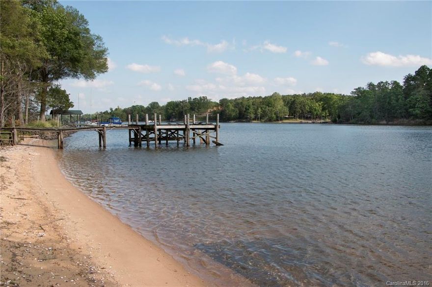 Waterfront lot on Lake Wylie, ready for you to build your lake home!  Cleared homesite, level, and big open view of the Little Allison channel, an ideal area for boating and water sports. You'll love sunning and watching the kids play on the wide sandy beach along the shoreline.  Approx. 1.4 acre lot is surrounded by woods for privacy. Old boat ramp for easy launch of canoes and small craft.  Dock in place, in need of repair. No HOA, excellent Clover schools, great place to call home!