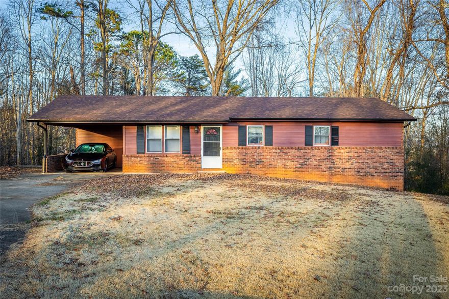 Affordable 3-bed/1.5-bath brick ranch in a small neighborhood less than 3 minutes from I-40! This home offers an open-concept dining area and kitchen with ss appliances. The primary bedroom has a private half bath and is generously sized. A 30-year roof was installed in 2021. Great storage space or potential finished space in the full basement. Outside, enjoy the mostly flat 0.86-acre lot, attached carport, and back deck. This home is being sold as-is.