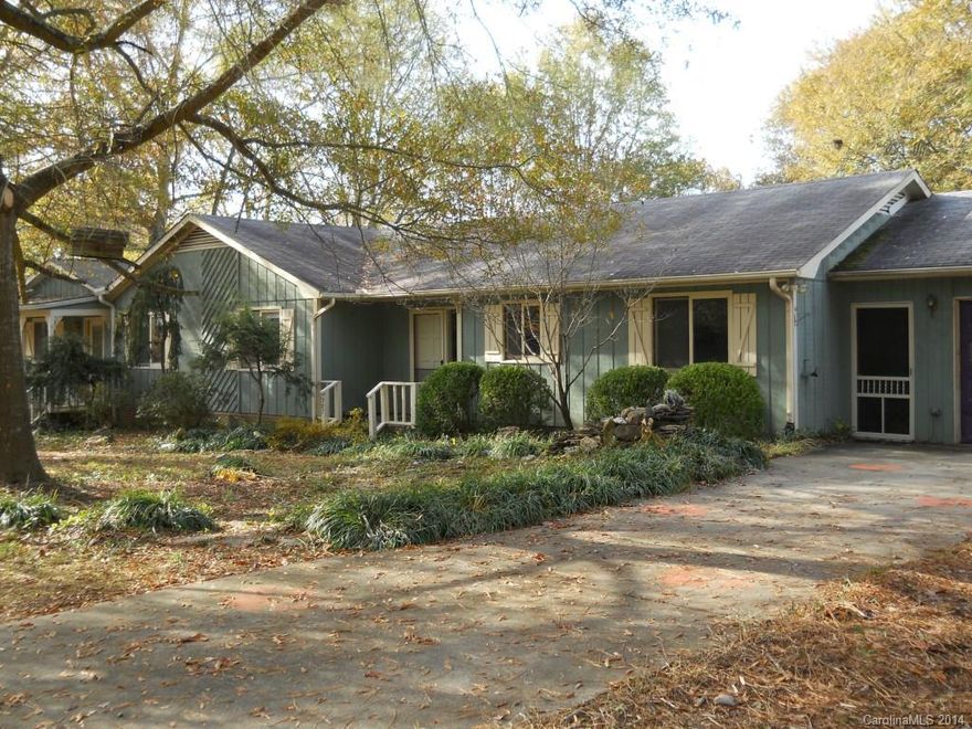 Spacious Ranch home with additional unfinished expansion with private entry.Located in coveted Ft. Mill School district, in an established community.  This is a DIY project with lots of possibilities.  Large great room with stone fireplace with woodstove insert.  Kitchen has eat-in area,  and formal dining room. Master bedroom has two large walk in closets, as well as access to Large deck off the back of the home. Home sits on lg lot/ fenced in. Additional workshop behind the garage/storage shed