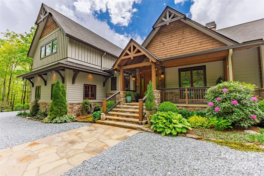 This impeccably maintained custom home in gated Whitewater Ridge community presides over beautiful gardens and offers a stunning long range Whiteside Mountain view. The 11 acre estate is surrounded by thousands of acres of National Forest, offering three hiking trails and access to waterfalls and the wild and scenic Whitewater River. Its setting among the native rhododendron and mountain laurel offers both privacy and quiet found in its natural surroundings. Throughout the home, you'll find thoughtful design and exquisite attention to detail. The main living areas are oriented to maximize the spectacular views, and the covered porch and decks feature unobtrusive post and cable railings. The great room is a highlight, with its soaring wood cathedral ceiling, wood floors, and a floor-to-ceiling stone and Italian tile wood-burning fireplace. The chef's kitchen is equipped with Thermador appliances, dual workstations, and ample ceiling-height cabinetry. A large pantry with an additional refrigerator/freezer, beverage cooler, adjustable shelving, and a recycle center is conveniently located nearby. The spacious primary suite located on the main level features a cathedral ceiling, a linear gas fireplace, custom maple and cherry cabinetry with a "waterfall" design, a zero-entry shower, and a heated bathroom floor. On the opposite side of the home’s main floor, a private guest suite awaits, complete with wood floors, abundant natural light, a large closet, and an en-suite bath. The main level also includes a generous laundry room, a powder room, a home office and a small keeping room with a gas fireplace adjoining the kitchen. Upstairs, you'll find two additional bedrooms and a spacious bathroom with double vanities and a tub. A large family room is situated above the two-car garage. The lower level, built into the sloping terrain, offers an art room, extra storage space, a third garage for an ATV and easy access to the home's mechanical systems. This exceptional estate also features desirable amenities such as a 22Kw generator, a whole-house water filtration system, a dual fuel heating system, and energy-efficient spray foam insulation in the walls and ceilings, ensuring comfort and peace of mind.