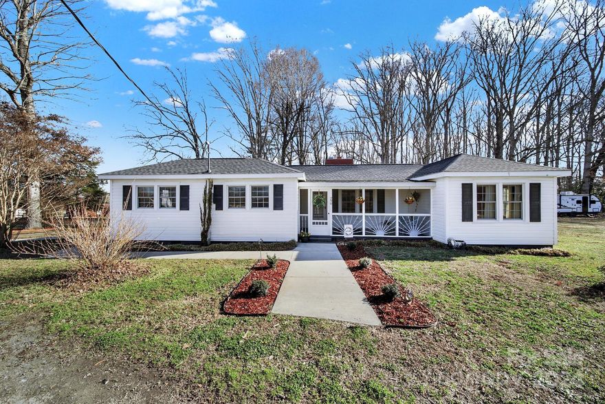 Welcome home to this adorable country cottage sitting on just under 2 acres that is perfect for building a family compound. Pull into the convenient circular driveway & notice the cute, screened-in porch as an entry way to the front door. Enter to find a whitewashed brick fireplace as the focal point of the living room paired beautifully w/ the original oak hardwood floors. Go to the left to find a dining/flex room & a large kitchen w/ dining area. Off the kitchen is the laundry room which is also quite roomie. Additionally there are 2 bedrooms with brand new carpet (2023) & a bathroom that was also updated in 2023 with new flooring, hardware, vanity, and shower surround. Moisture barrier & chainlink fence added in 2021, electrical updated in 2021, & new roof installed in 2022. Stroll around outside & find the sheds, carport, playset & there's even a trail to explore in the woods. Don't miss out on your chance to live a country life still close to the city!