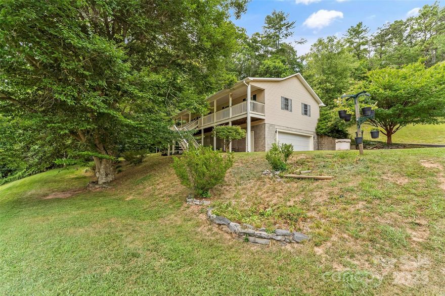 Beautiful 3BR/3BA ranch home with bonus room on 1.29 acres surrounded by serene natural settings only 6 mins to downtown Weaverville and 12 mins to downtown Asheville. This home offers the perfect blend of peaceful country living while still being close to shops and amenities. Relax on the covered front porch or rear porch and take in the natural surroundings. The main level features an open floor plan, a cozy fireplace, hardwood flooring, windows for natural light, and ample living space and kitchen.  The finished basement with walkout access provides second living quarters, currently used as 4th bedroom, with a kitchenette and bathroom perfect for in-laws, guests, or rental! Two-car garage with a workshop.  An unbeatable location!  15 minutes to Asheville.  5 minutes to Weaverville.