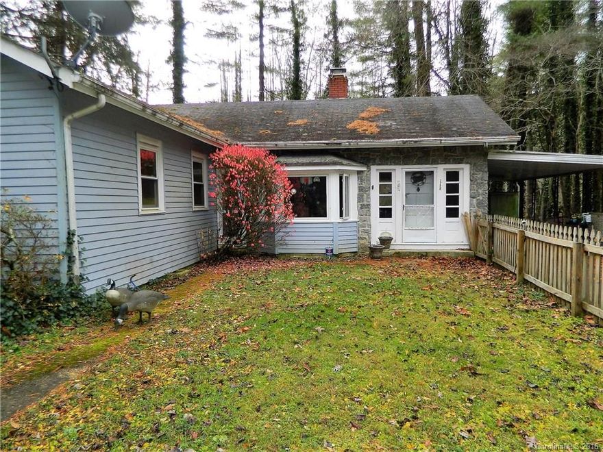 Terrific opportunity for remodeler!  2-bedroom 1 ½ bath cottage, private, partially fenced level lot. Hardwood floors, gas fireplace in living room, built-in bookcase, knotty pine walls, car port, out buildings. Would make super cute vacation rental.  Home needs some updating & repairs. Only 10 minutes to Downtown Hendersonville!  Don’t Miss this one!