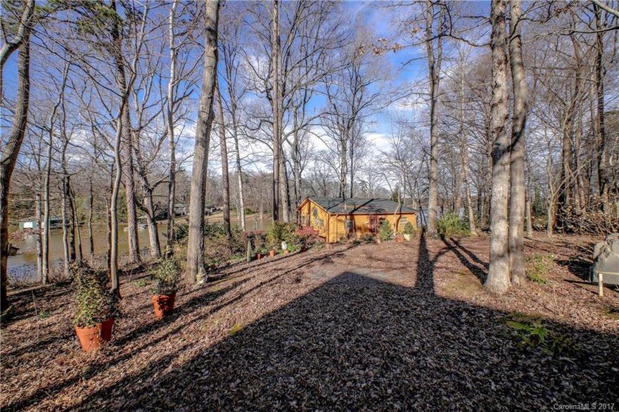 Beautiful waterfront Lake Wylie lot with fishing cabin and shed on property. being sold for lot value only and no entry to cabin. The deep water, main channel view lot slopes and is the perfect place to build. Low Taxes, Clover schools and an easy commute to Charlotte area. The is a large well maintained dock already in place. Bring your builder for a look! Lot 60 next door is also for sale 6946 Pine Moss Lane.