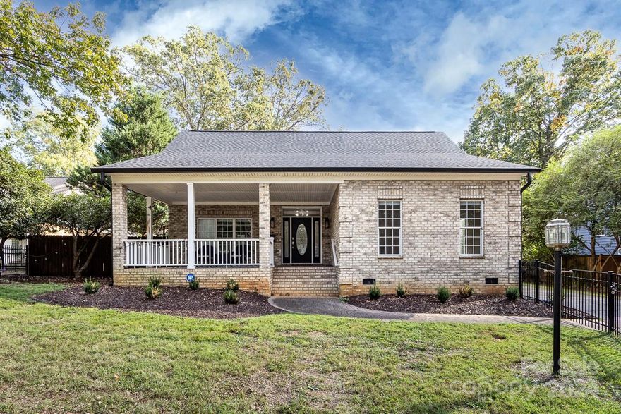 Charming recently updated brick ranch on over half an acre! Open concept floor plan perfect for entertaining! Expansive living room with vaulted ceilings and gorgeous new walnut floors throughout. Kitchen open to dining and living room  and has updated cabinet and quartz countertops. Enjoy entertaining friends in the enclosed sunroom and step outside to the private side patio. The primary bedroom has a stunning ensuite, just remodeled with gorgeous marble tile, dual vanity, walk in shower and soaker tub. Large primary closet completes the suite. Two secondary bedrooms in a separate wing, with a beautiful guest bath. The oversized fenced in backyard is perfect for a large pool, play equipment or backyard football! Front yard also enjoys a new fence with gate. Two-car attached garage features brand new garage door and opener, plus plenty of storage. New roof, electrical, newer HVAC (4 years). Ideal location minutes to great schools, Southpark, shopping, restaurants and uptown Charlotte.