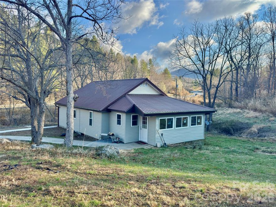 Looking for move-in ready convenience with cozy cottage charm? This adorable home just minutes from Mars Hill is a must see. Inside you’ll find warm tongue-and-groove walls, charming barn doors, and an efficient mini-split system to keep the home comfortable year-round. The layout offers 2 bedrooms and 2 full baths, including a main bath with a built-in heating feature for extra comfort.

The kitchen includes a pantry closet, and a bright sunroom with laundry at the far end provides flexible living space. Enjoy peaceful mornings on the front porch with your coffee, surrounded by the quiet of the countryside.

Recent improvements include a newly installed crawl space encapsulation, and the property now features an additional 0.4 acres, giving you even more room to enjoy the outdoors. There’s also space for a small garden, perfect for flowers, herbs, or vegetables.

Charming, efficient, and ready to welcome you home. ????