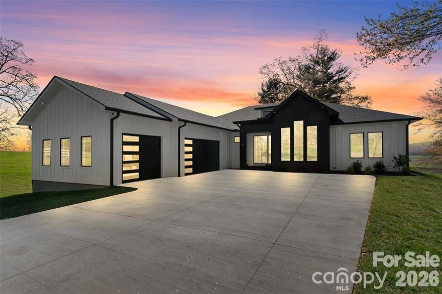 Welcome to your dream home! This custom-built, one-level home blends luxurious comfort with convenience. You’ll be greeted by soaring ceilings and an open floor plan making the space feel spacious and inviting. Kitchen features Taj Mahal quartzite counters, soft-close cabinets, and large pantry allowing for plenty of storage while also housing an ice machine. Primary suite includes a walk-in closet and a spa-inspired en-suite bath with a standalone soaking tub, walk-in shower, heated floors and dual vanities. For ultimate relaxation, unwind in the built-in sauna attached to a separate 325 square feet of versatile living space. In the living room, glass doors open to the back patio, offering beautiful views of the peaceful surroundings. Bedrooms are spacious, providing the perfect spot to recharge. With upgraded finishes throughout, this home is designed for those who value quality craftsmanship. Just 30 minutes from Asheville and 15 minutes from Biltmore Park, this home offers peaceful living and easy access to all Asheville has to offer.