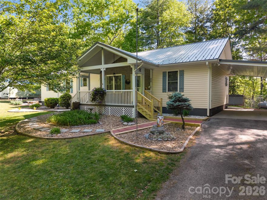 Enjoy the ease of one-level living on 6.4 private acres, offering space, flexibility, and endless possibilities. This 3-bedroom, 2-bath home features a spacious layout designed for comfort and functionality. The large primary suite provides a peaceful retreat with a walk-in closet, soaking tub, and separate walk-in shower. A bonus room and bright sunroom expand the living space, perfect for a home office, gym, studio, or hobby area. Storage is abundant throughout the property, complemented by a carport, detached garage, and a large outbuilding—ideal for projects, hobbies and toys. Located only 4.5 miles to the entrance to Pisgah National Forest this property is convenient to outdoor adventures while providing a quiet and private oasis.  Whether you’re seeking privacy, room to grow, or versatile spaces to fit your lifestyle, this property delivers it all.