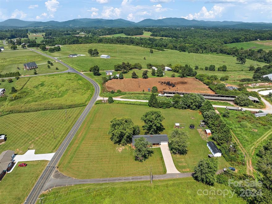 Timeless charm, modern upgrades, gorgeous mountain views from this updated 4BR 2 BA home is country living at it's finest. This charming brick ranch is situated on just under 3 acres of land, offering the perfect setting for a mini farm or homestead. Stunning mountain views year-round, providing a picturesque backdrop for daily life. Many upgrades from 2018-present include new roof, windows, flooring, tankless hot water heater, HVAC, appliances, kitchen remodel, baths remodel, plumbing, fixtures, ect. Too many to list here. 5 bedroom septic tank installed June 24', providing flexibility for your future needs. Home is connected to city water, and spring fed well serves garden, animals, ect.-could easily be connected back to the house if desired. Custom playhouse, duplex chicken mansion with automatic doors, and extra large building/workshop invite you to stay out and play as long as you'd like. Schedule your showing and be in your new home before the leaves change! Agent is owner.