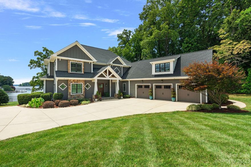 This stunning, modern craftsman, waterfront home combines exquisite, custom finishings with casual luxury. Panoramic water views are the focus of the homes thoughtful, open floorplan. Custom millwork and built in features throughout. Main level primary suite with custom dual closets, great room with cedar beamed ceiling, open to outdoor travertine deck and pool, a gourmet kitchen, anchored by a custom walnut island and stainless steel hood, Wolf and Subzero appliances and butler's pantry. Sliders open from the kitchen to the vaulted, beamed, covered porch with stone fireplace, IPE decking, cable railing and outdoor kitchen, travertine deck with saltwater pool/hot tub. convenient 1/2 bath, stone firepit. Covered dock and swimming platform. Upstairs there are two large bonus/flex rooms, an office with built ins and additional insulation for sound, 3 bedrooms. Abundance of storage, oversized 3 car garage. Prime location just outside the Point, no HOA. Fabulous lakeside entertaining home!