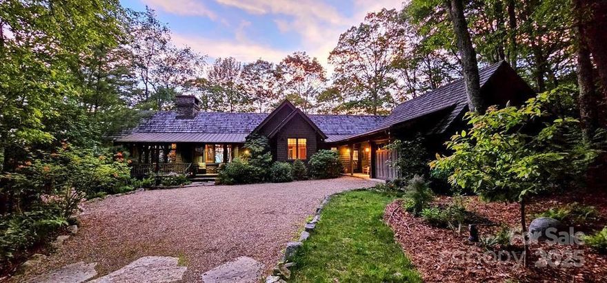 Perched at 4,600’ on a private ridgeline, this Al Platt-designed home in Balsam Mountain Preserve offers stunning sunrise and sunset views in a conservation community where 3,200 of 4,400 acres are permanently protected. With heart pine floors reclaimed from the Ivey Cotton Mill, oversized windows, and radiant heat on the lower level, the home blends rustic charm with thoughtful design. The main-level layout includes 3 bedrooms with ensuite baths and a bonus room/office with its own half bath, connected by a breezeway for privacy and flexibility. Outdoor living shines with a screened porch with wood-burning fireplace, wrap-around deck, and flagstone patio—all surrounded by native landscaping. The small, close-knit neighborhood encourages connection and shared appreciation for the land. Enjoy access to Balsam Mountain Preserve’s amenities including golf, equestrian center, nature center, dining, and more. This is more than a home—it’s a lifestyle rooted in nature and community.