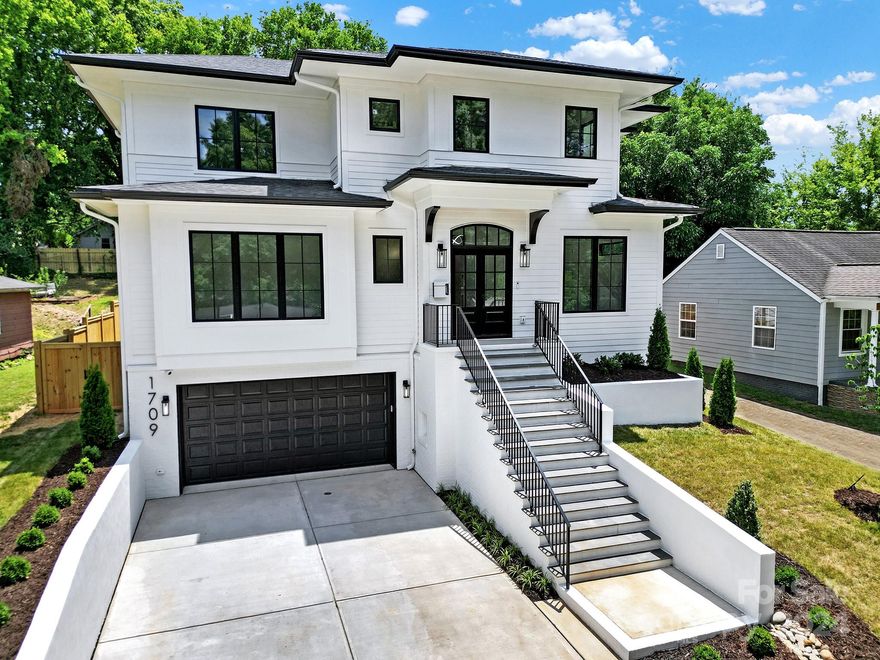 Welcome to this luxurious, custom built home located in sought after, up and coming, Wilmore!! This stunning three floor residence boasts unparalleled craftsmanship with an open floor plan, top of the line finishes and a fully finished basement. With ample space for outdoor living and entertaining, enjoy ultimate privacy with all of the perks of uptown living. The centerpiece of the first floor is the full glass, independently cooled, wine vault holding close to 300 bottles! Features include crown moldings throughout, 4" red oak hardwood flooring, gorgeous chef's kitchen with Calacatta Arezza quartz countertops, Z-Line 60" RL refrigerator, 46 gas range, stainless steel appliances, massive center island, large walk in pantry...the list goes on and on. This residence is within walking distance to Panthers stadium, Charlotte uptown, retail, dining & nightlife. Massive future value potential with proposed redevelopment on adjacent 55 acres lot. Don't miss this opportunity!