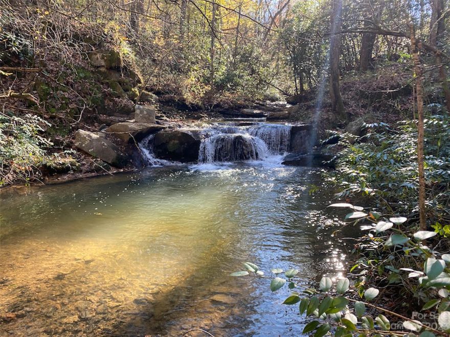 A special 382 rolling wooded and pastoral acres just outside of Old Fort NC.  The property has over 1.2 miles of Brevard Creek flowing through the center of the property and several other creeks and streams and a near 0.8 acre pond.  The original home is standing but not habitable.  With 0.7 of a mile of paved road frontage access is great.  There is approximately 30 acres of pasture, miles of old trails and great mountain views.  This property lends itself to so many uses from private estate, equestrian retreat or development parcel, compound.  NEW Boundary survey on file 2/9/2023