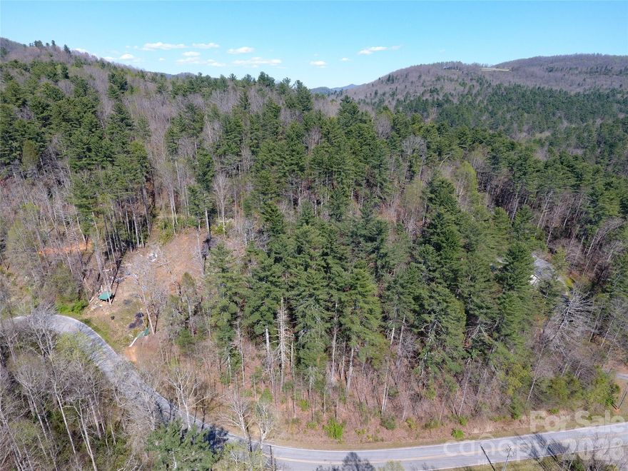 Beautiful Wooded Building Lot with Mountain Views in Zirconia.
Discover the perfect opportunity to build your mountain retreat on this 0.80-acre wooded parcel located on Rock Creek Road, just off Green River Road in the serene Zirconia community of Henderson County, North Carolina. Tucked away in a peaceful, rural setting, this easy-build lot offers a gentle topography that makes construction straightforward, whether you're dreaming of a custom stick-built home or a manufactured home (which is allowed here).
The property is beautifully wooded with mature trees, providing natural privacy and a sense of seclusion while opening up to captivating mountain views. Enjoy the tranquility of Western North Carolina's foothills, where the air is fresh and the surroundings are filled with the sights and sounds of nature.
Residents of this area benefit from access to the stunning Lake Summit, a highlight of the community offering beautiful reservoir views, boating, fishing, and recreational opportunities on one of Henderson County's largest and most scenic lakes. Additional perks include no city taxes and no HOA, giving you the freedom to enjoy your property without extra fees or restrictions.
This lot is conveniently situated between Asheville and Greenville, with easy access to Hendersonville for shopping, dining, and amenities, yet far enough away to feel like a true mountain escape. Whether you're looking for a full-time residence, weekend getaway, or investment property, this versatile parcel in desirable Zirconia is ready for your vision.
Don't miss your chance to own a slice of Henderson County's natural beauty.