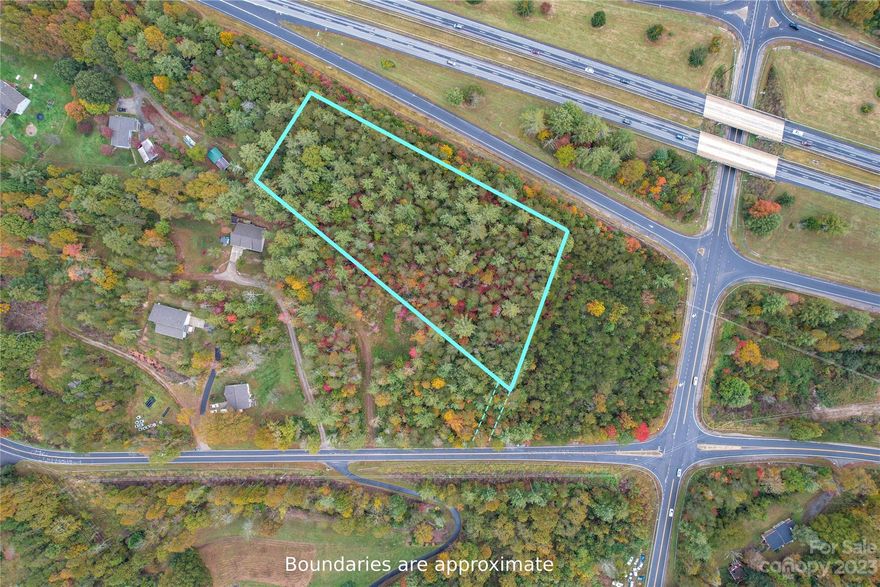 Calling all developers and entrepreneurs! Snap up this amazing 2.78 acre lot with Open Use zoning, just 7 minutes from Downtown Weaverville.  With 512' of off ramp frontage at the Jupiter exit from I-26, and daily traffic counts above 27,000, this location offers excellent visibility at a location which will only get busier as Weaverville grows.    Don't let this opportunity slip away!  There is a 20' wide easement from the property to Old Mars Hill Highway where a driveway can be installed. Contact Realtor regarding procedure for modifying guard rail.  Culvert and driveway will need to be installed to bridge from Old Mars Hill Hwy across the ravine to the property.