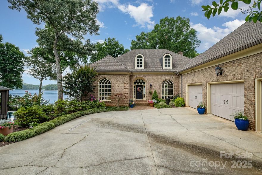 Your Private Lake Norman Oasis Awaits!  Now is the perfect time to make this exceptional waterfront retreat your own. Just 20 minutes from Charlotte & only 3 miles from vibrant Birkdale Village, this rare gem offers over an acre of beautifully landscaped privacy with sweeping open-water views of Lake Norman. Tucked away among mature trees, this serene property invites you to relax and unwind. Take in breathtaking sunsets from your covered private dock, entertain on the expansive Trex deck, or enjoy a peaceful morning on the screened porch with the sounds of nature all around. Inside, a thoughtfully designed open-concept floor plan maximizes the stunning lake views while filling the home with natural light. There’s plenty of space to spread out, with three generously sized bedrooms, updated bathrooms,  a large fourth room that could easily be converted into a bedroom with a city sewer connection (available), and an additional bonus room upstairs perfect for a home office or guest space