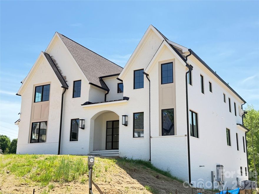 This spectacular home in the heart of Davidson showcases size, quality and luxury, with over 6,150 sq ft with all the custom features you could imagine.  An impressive elevation with a focus on the front entry.  A custom 9' door system (with a 60" pivot style door) invites you in to an open floor plan.  As you step into the great room with 12 ft coffered ceilings, the home’s custom details are immediately apparent.  Your eye will be drawn to a fireplace ready for wood burning or gas logs. The Chef's Kitchen features Sub-Zero Fridge and Freezer columns totaling an impressive 5 ft in width; an expansive island; custom inset cabinets and a 48” Wolf range.  Walking through the kitchen, you'll find an expansive larder/pantry designed to showcase a custom finish while meeting functionality.  Outside of this one-of-a-kind pantry, the vaulted ceiling of the dining room (with four handsome beams) will have you envisioning future gatherings.  Open the expansive sliding doors and walk out to the massive screened porch (with wood-burning or gas fireplace). 

 5 Bedrooms and 5.5 Bathrooms.  The primary bedroom is on the main level, with a spacious bathroom including a huge shower, freestanding tub and 17 feet of custom cabinetry along separate vanity spaces.  The closet is oversized and plumbed/wired for stackable washer/dryer appliances.

Three car garage with extensive vertical space.  Upstairs, an impressive In-Law Suite with a sitting area, full bathroom and walk-in closet.  The three remaining rooms are very spacious with full bathrooms and walk-in closets.  The rear bedroom features a walkout balcony with a terrific view of the backyard and wooded area. The laundry room will be the envy and driving force of the upstairs living space.  The upstairs family room can house any entertaining idea(s) you desire. 

 Finally, the builder welcomes the opportunity to finish the basement with immense space for an additional bedroom....golf simulator....workout space....kitchen....living space or whatever you can envision.  This lot is perfect for a future pool and backyard oasis.  The entertainment value on this property is enormous. 

This is your chance to live in one of the most highly desired areas in all of North Carolina.  The neighborhood is just off of multiple entries to the Davidson Greenway; and a quick bike ride from Downtown Davidson.  Enjoy Concerts on the Green, Christmas in Davidson, the Thanksgiving Turkey Trot, Trick-or-Treat Davidson and the weekly Farmer's Market.  Or take in a Davidson College sporting event.  

Davidson Woods is minutes away from River Run Country Club.  Enjoy the best golfing, tennis, pickleball, social and dining accommodations by one of the most well-known Country Clubs in NC.  Davidson Woods is only 30 minutes from Uptown Charlotte and Charlotte Douglas International Airport. It’s under a 15 minute drive to Mooresville, Cornelius, and Birkdale Village (Huntersville).  

Please contact the listing agent for your private tour and walk through with our hometown trusted builder, Trey Williams.  We would love to share our vision from the design team, but are open to making this property custom to your needs.