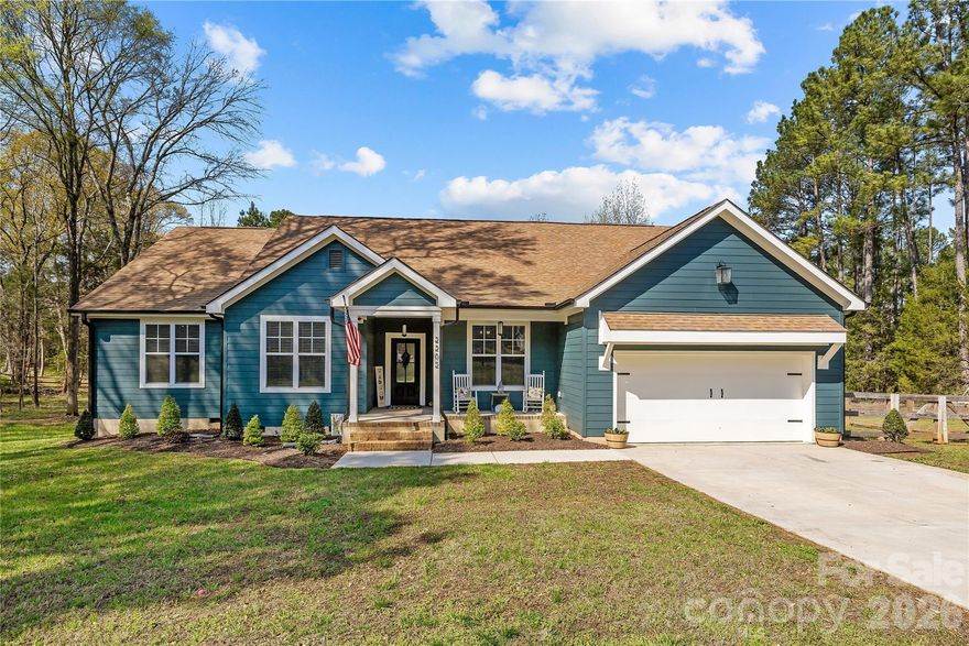 Experience refined, single-level living in this exceptional custom-built estate set on 1.25 acres of private, usable land. Thoughtfully designed with both everyday comfort and elevated style in mind, this one-of-a-kind residence offers a rare combination of quality craftsmanship, functional layout, and timeless finishes. The bright open-concept design is enhanced by soaring 10-foot ceilings in the main living area and 9-foot ceilings throughout, creating a light-filled, airy atmosphere. High-end waterproof LVP flooring flows seamlessly through the main living spaces and select bedrooms, delivering both durability and sophistication. At the heart of the home, the chef’s kitchen showcases custom floor-to-ceiling cabinetry, striking leathered granite countertops, island with farm house sink and thoughtfully designed built-in pantry surrounding the refrigerator - offering both beauty and exceptional storage. The flexible floor plan includes 4 spacious bedrooms, two and a half baths, and a versatile flex space with tray ceiling ideal as a formal dining room, private office, or playroom. Custom closet systems throughout add a level of organization rarely found at this price point. The primary suite serves as a true retreat, featuring a tray ceiling, private access to the expansive rear deck, and a spa-inspired bath complete with a freestanding soaking tub and oversized walk-in shower. Step outside to a deck spanning nearly the full length of the home - perfect for entertaining or enjoying quiet evenings overlooking the large, flat, fenced backyard. The outdoor space offers exceptional versatility, featuring a dedicated chicken coop and animal corral—ideal for hobby farming or those seeking a more self-sufficient lifestyle—along with ample room for a future pool or expanded outdoor living. Additional highlights include an existing playset that will convey with the home, while the trampoline does not convey. Ideally located just minutes from downtown Rock Hill, this property offers the benefit of low county taxes while maintaining convenient access to dining, shopping, and everyday amenities. Priced Right for Quick Sale. Do Not Wait On This One – Bring Your Offer Today!