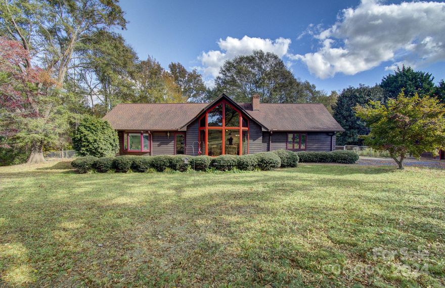 This beautiful cedar, prow-styled home is nestled on approximately 5.7 unrestricted acres just outside Rutherfordton, NC. This spacious 2-bedroom, 2-bath home offers a rural lifestyle built for entertaining and outdoor activities. The home radiates charm and warmth-- a comfortable layout makes every room feel inviting. A great room features a vaulted ceiling, fireplace, and sunset-inviting, floor-to-ceiling windows. The property includes 2 industrial-grade spaces, ideal for woodwork, craft, or home-based business. These large garages are perfect for creative or professional pursuits. Outside, you’ll find a fenced backyard complete with garden storage, chicken coop for fresh eggs, and thriving garden with raised beds ready for vegetables, flowers, or whatever you envision. Beyond the fenced section are 3.5 acres of your own woodland to explore.  This property offers endless possibilities to pursue projects, enjoy nature, and savor the privacy of this unrestricted setting.