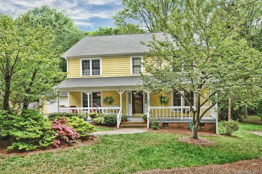 Charming! Welcome friends from your rocking chair front porch! Beautiful home with spacious formals, large den with fireplace, gorgeous high-end laminate floors. Sunny eat-in kitchen features granite, double oven. Bedroom/bath down perfect for guests, and 3 large bedrooms up include huge master suite. Craftroom off 3rd Bedroom. Big closets, storage galore! Step onto the tiered deck and look over 3/4 acre yard backing to Carmel Middle, and leading to deep 2-car garage. Roof 2014. H20 '12