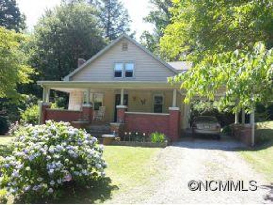 This home is overflowing with vintage charm!  Original hardwood floors and lovely original woodwork.  Large rooms and plenty of square footage. Cozy living room with french door into formal dining.  Spacious kitchen with updated cabinets and lots of built in storage.  Rocking chair porch with attached carport and lovely flowering shrubs.  30 x 30 workshop/garage, currently rented.