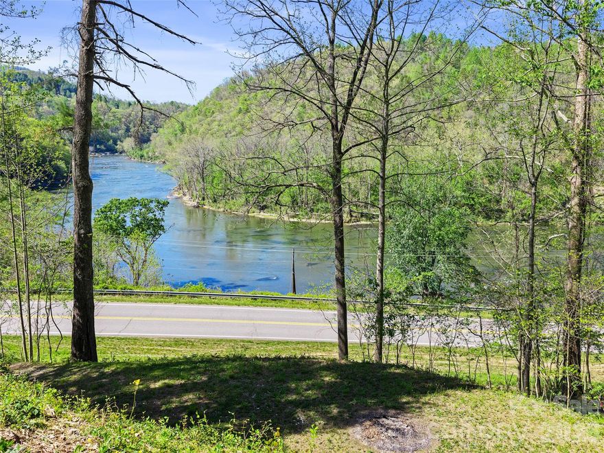 Buildable homesite cleared, level and ready for home of any flavor to be built within this one acre of surveyed wooded land.Parcel has road frontage on Little Pine Road, as well as a gentle sloping driveway to homesite.Parcel can truly boast of one of a kind direct views of French Broad River's Bend meandering through the picturesque beautiful mountains of WNC near the quaint town of Marshall on the river.Owners have a successful perc test and applied and obtained a septic permit for a 3 BR septic which has expired this March and will have to be reapplied for by new owner. Highlights of this area include: River Rafting and Canoeing and Horseback Riding and a thriving local arts culture with several good restaurants in Marshall just minutes from this land.  Just 20 miles more and one could find themselves in the larger area of Asheville, NC with even more amenities to enjoy in  popular Western NC.