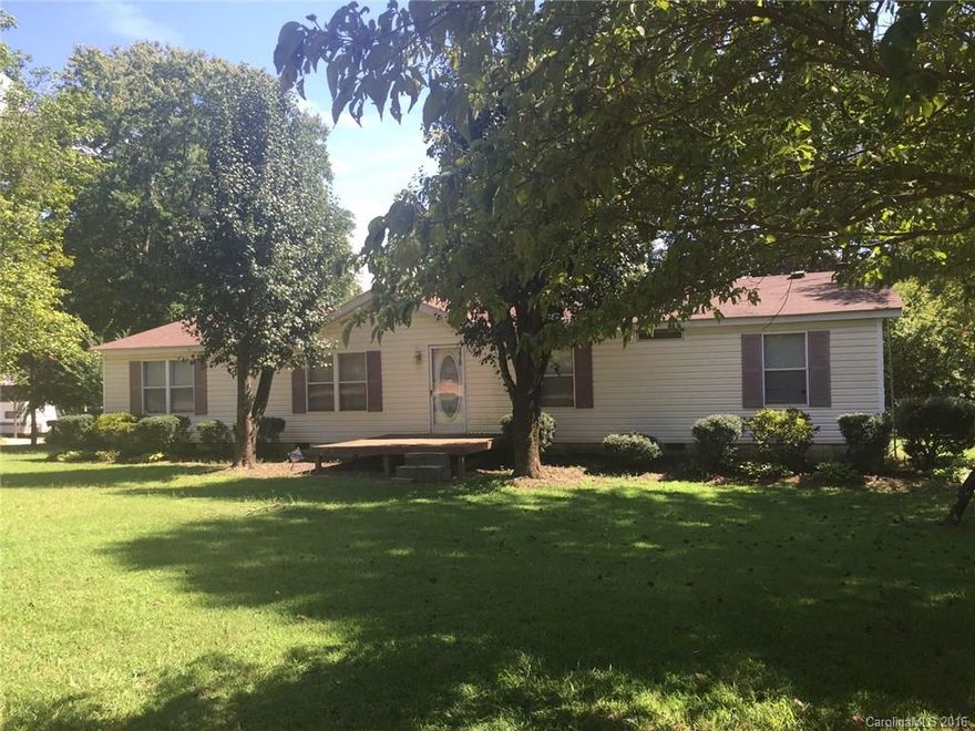 Quiet country living in this nice 3 BR, 2 BA doublewide on a large corner wooded lot. Home is a split floor plan with lots of living space and very open plan. Large kitchen opens to dining area and great room with fireplace. Master is spacious and the MBR has a garden tub.