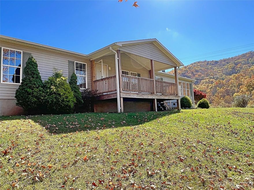 Nestled on a grassy knoll with mountain views all around, with a rocking chair front porch that you can sit and enjoy not only the views but the quiet flow of the bold creek across the street sits this spacious 3 bedroom 2 bath home. This home features a large kitchen with island that opens up to a den with fireplace. These two spaces have tons of natural light making the home feel airy and bright. The home also boasts a separate dining room, spacious living room, huge primary suite, and two additional bedrooms with a bathroom in between. This home is in need of cosmetic repairs and some TLC. The roof is older and will need to be replaced in the next few years but currently has no leaks. The seller recently replaced the well pump, pressure tank, and all electrical to the well. The septic was pumped and inspected in 2023. RV hook-up (electrical & sewer) was added to the side of the home in 2023. Cash would be preferred/possible conventional loan.