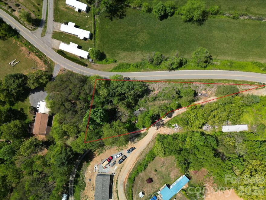 Looking for a build-ready lot in Canton with utilities already in place? This 0.51-acre property at 32 Windy Hill Lane offers a rare opportunity to place a manufactured home with a 2-bedroom septic system on file, access to a community well, and a level homesite with mountain views.

Rare opportunity to own a 0.51-acre lot in Canton, where manufactured homes are allowed, located in the Michael D. Crawford community with light restrictions. The property features a level homesite, mountain views, access to a community well, and a 2-bedroom septic system  (permit on file), making it an ideal setup for a new manufactured home. An existing single-wide manufactured home is on site, but is in poor condition and is being sold as-is, with no value assigned. The true value is in the land and the ability to build or place a replacement home with utilities already established. Haywood County Schools, including Bethel Elementary, Bethel Middle, and Pisgah High School. This 0.51-acre lot in Canton, where manufactured homes are allowed, is a rare and affordable opportunity at $35,000 for buyers or investors seeking a ready-to-use homesite.