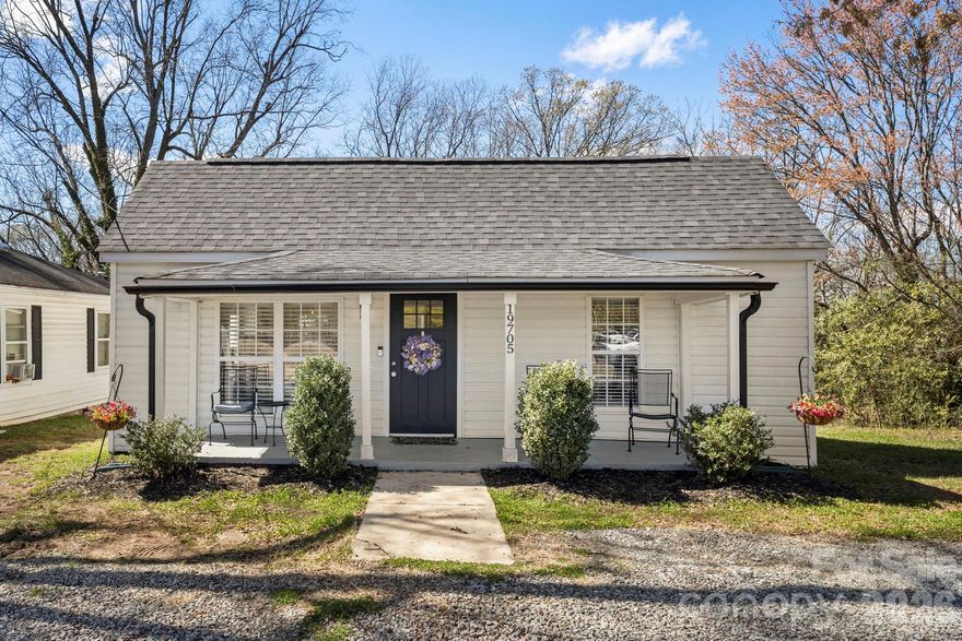 Some homes have a zip code. This one has a lifestyle. Built in 1916 and fully renovated in 2020, 19705 S Ferry Street sits in the heart of Old Town Cornelius, one of the most walkable, livable neighborhoods in the Lake Norman area. Two bedrooms, two full baths, 983 square feet of thoughtfully updated space, and a location that lets you leave the car parked all weekend. The interior is clean and move-in ready. Open-concept living, granite countertops, stainless appliances, soft-close cabinetry, and updated plumbing and electrical throughout. The HVAC and roof are both new as of 2019/2020. Nothing deferred. Nothing to fix. Outside is where this home earns its keep. A new deck was recently added, giving you a proper outdoor living space to go with the covered rear porch and fire pit. Whether it's Saturday morning coffee or a Friday night fire with friends, the outdoor flow here is better than homes twice the price. And then there is the location. Walk to grab a coffee. Grab dinner at many local restaurants like Barrel and Fork or the Harp and Crown. Walk or bike to the Second Friday Street Festival in Old Town, Farmer's Market in Davidson. Jetton Park, Ramsey Creek Park, Birkdale Village and Lake Norman are minutes away. Davidson College and downtown Davidson are less than five minutes down the road. I-77 puts you in Charlotte in under 30 minutes. Great TOP-RATED schools! Town of Cornelius has confirmed an ADU (accessory dwelling unit) is permitted on the rear of this property, offering exceptional potential for a guest suite, in-law quarters, or rental income. Shed that can be seen in photos belongs to the neighbor.