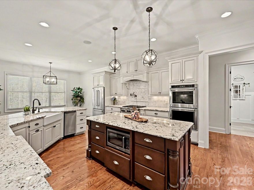 Exceptional Living Space, Style and Serenity!  Welcome to this timeless all brick & stone feature-rich home!
Beautifully maintained, offering 3,591 sq ft of living space, thoughtfully designed for comfort, flexibility and everyday luxury. Set on just over an acre of land in a highly desirable amenity-rich community near Lake Wylie. Offering living at its finest with privacy, space and room to grow!  The interior of this home boasts a chef’s gourmet kitchen which features a gas range, pot filler, double oven, stainless steel appliances, stand-alone ice maker, farmhouse sink, granite countertops, cabinets and counter space galore. The open concept living room, brings a warm focal point to the home with a large gas fireplace and gorgeous built-in cabinets. The primary bedroom with upgraded LVP flooring and ensuite can be found on the main level which includes expansive his & her walk-in closets. Enter through the impressive French doors on the main level to a flexible room that can be used as an office, library or formal dining room. Finally, a functional laundry and ½ bath all on the main floor. Beautifully maintained hardwood floors shine throughout the main level leading to the three-car garage with built-in shelving. The basement level has unfinished space with a garage door for cars, tractors, workshop, man-cave, she-shed and a ½ bath.  Climbing the curved oak staircase to the upstairs, you will find upgraded LVP flooring in all bedrooms and living areas, three generously sized bedrooms, and two more full baths. 

Enjoy the outside of this property where privacy and space abound. The expansive fully fenced backyard is ideal for pets, child play and entertaining. Easy access to the ½ bath makes outdoor entertaining wonderfully convenient. Wander through an abundance of garden features, including: apple, peach, and fig trees, a pawpaw tree, blueberry, blackberry, and raspberry bushes, flower beds and herbs. Zoysia grass in the front lawn provides low maintenance with a front yard irrigation system. Peace of mind comes with your new home in a hard-wired security system and central monitoring. This home comes with two lots/parcels and therefore two HOA Boat/RV storage spaces on site, twice the storage of most homes!  Award winning Clover schools to include the new state of the art schools set to open in Fall of 2026, and this home has been re-zoned for these amazing schools beginning in fall of 2026. For school information visit: https://www.clover.k12.sc.us/o/district/page/student-reassignment-2025

Life here provides easy access to Lake Wylie for boating, fishing, sun and fun! Easy access to downtown Charlotte and CLT International Airport. Many small trendy restaurants and shopping is nearby to enjoy, as well as malls and grocery stores for your everyday needs.

This amazing home seamlessly blends space, functionality and lifestyle – offering the freedom of acreage and the convenience of community amenities, with the comfort of thoughtfully upgraded interiors. Whether you are entertaining, gardening, working from home or just simply enjoying a quiet evening by the fire, this property delivers a rare combination of flexibility, charm and class.   Come see it today and call it HOME!