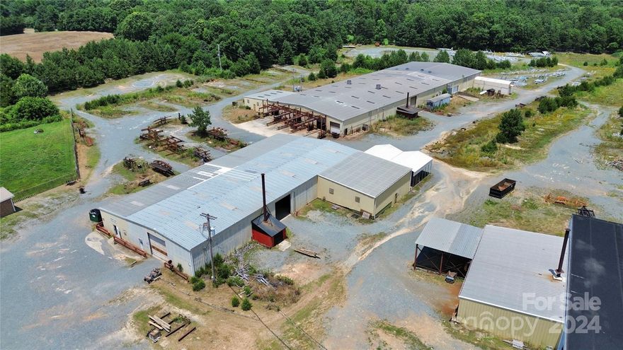 Hudson Brothers Trailer Manufacturing presents a rare investment opportunity in Union County. Established in 1971, this family-owned and operated business has garnered a legendary reputation for producing high-quality flatbed trailers nationwide. With the owners retiring, this esteemed name & operation are now primed for transition to an astute investor seeking a lucrative venture. Property consists of 21.37 (+/-) total acres. Parcel 1 zoned residential is a vacant 7.74-acre lot, offering ample potential for expansion or alternative development. Parcels 2 & 3 are zoned industrial & serve as the nucleus for the manufacturing operations. Diverse infrastructure include 3BR/1BA brick home currently generating rental income. Office featuring lobby, conference room, private offices, cubicles & reception area. 2 shops plus parts warehouse consisting of 48,074 (+/-) total sqft of manufacturing space with 19 rollup doors, paint dept, dryer room, loading dock, & more! Prime location near I-485.