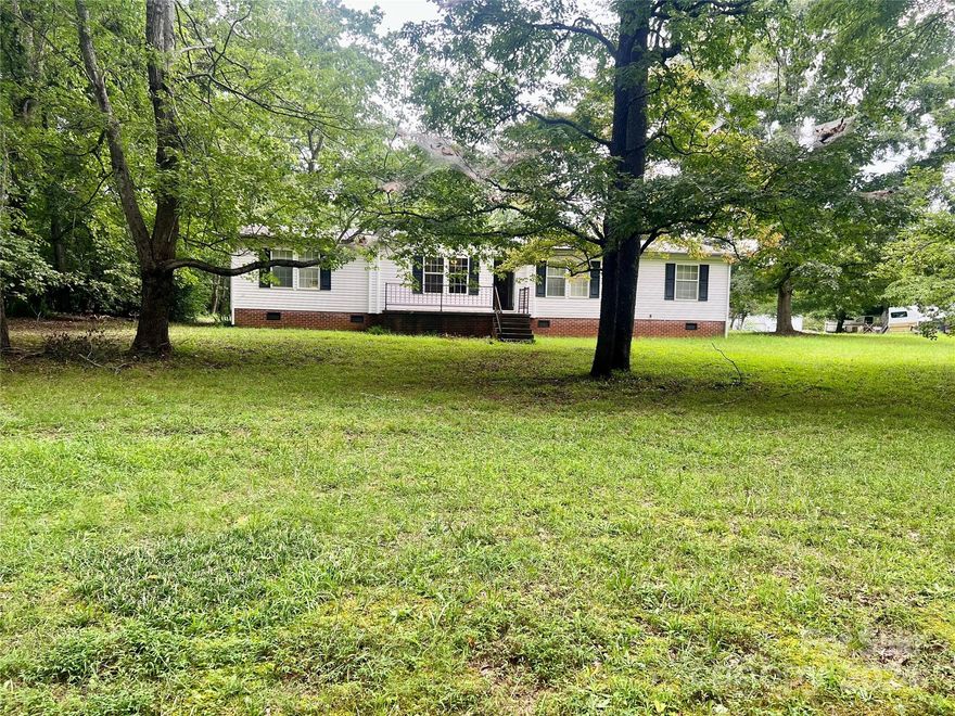 This is a good opportunity for investors or buyers looking for a fixer-upper in Alexander County, NC, featuring a 3-bedroom, 2-bathroom manufactured home on a generous 1.5-acre lot with a detached garage. The property boasts a spacious living area, a large kitchen with an island, and a dining room; however, it requires significant repairs, including needing a roof, HVAC system, plumbing, appliances, windows/doors, back deck, and more. Being sold AS IS, the asking price accounts for the required updates, making it ideal for cash buyers willing to invest in renovations (CASH BUYERS ONLY).
