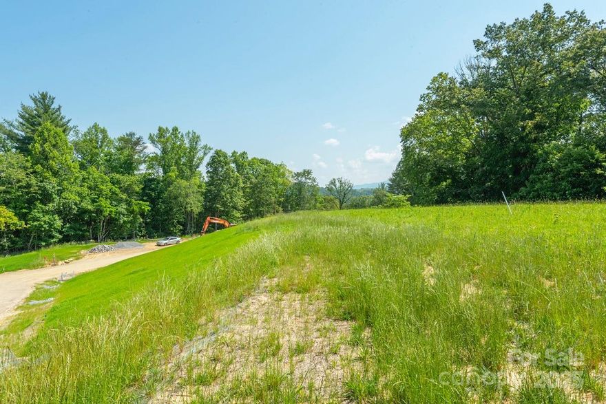 This sunny, easy-build homesite in Olivette’s newest neighborhood is a gardener’s dream, offering fantastic long-range views, great solar exposure, and a partially wooded setting with mature hardwoods—perfect for your dream home!

Just 6.9 miles to downtown Asheville, the Olivette agrihood is a 411-acre planned community featuring a riverfront park along the French Broad River. The heart of Olivette is a fully operational 4-season organic farm offering a CSA, farm stand, tailgate markets & other farm-centric activities. Connections to food, nature, community & the arts are essential concepts of our design. Residents enjoy access to miles of hiking trails, community gardens, orchards, a large private river island with pavilion & fireplace, fire circle amphitheater, suspended bridge to a private island, walking labyrinth, & dog park. Community infrastructure includes fiber optic cable, underground utilities, city water & sewer, and state-maintained roads.