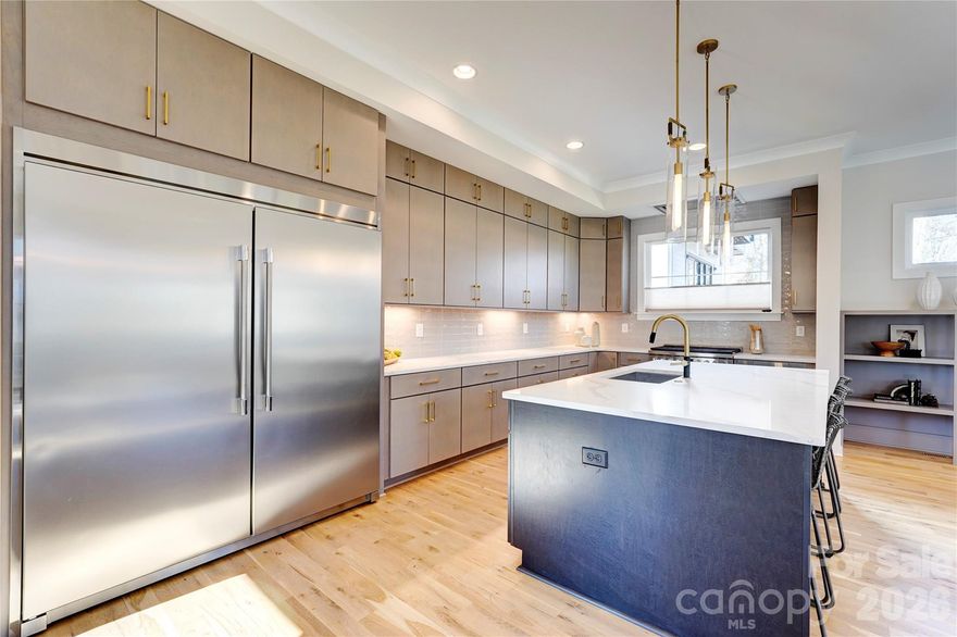 Your luxury new build awaits in this customized residence, featuring a rare full walk-out basement. Step through the dramatic two-story foyer into light-filled entertaining spaces framed by walls of windows. The kitchen is a true showpiece, with custom cabinetry to the ceiling, quartz countertops, a professional-grade built-in refrigerator/freezer, and a 36-inch gas range with commercial vent hood. It flows seamlessly into the living room with gas fireplace and built-ins, as well as the dining area. A main-level drop zone, powder room, and generously sized two-car garage add everyday convenience. Upstairs, you’ll find three bedrooms, including one with a Juliet balcony and a shared Jack-and-Jill bath. The primary suite spans the back of the home, complete with a vaulted ceiling and sliding doors to a private deck. Enjoy a custom walk-in closet and a spa-inspired bath with dual vanity and private water closet. The daylight basement offers exceptional versatility, featuring a spacious second living area with wet bar and wine fridge, an additional bedroom and full bath, walk-in storage, and doors opening to yet another deck, one of three across the rear of the home. This high-end home perfectly marries function and design, all backed by a full new-construction warranty. Ideally located in booming Oakhurst, just around the corner from dining, coffee, fitness, and more. Welcome home.