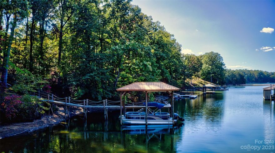 Charming 1611 sq ft cottage has 3 bed/2 full baths. Last house at the end of the lane this .61 acre is surrounded by woods and nature. Walk down to your private dock and feel like you are on vacation everyday! Large great room area w/ brick fireplace, spacious primary bedroom, there is room for all of your friends and family to enjoy time at the lake. Lots of windows for great lake views. 2 Large deck areas, one off the sunroom and one off of the primary bedroom, they are both perfect for relaxing while overlooking the quiet cove. Great location on the lake and with easy access to The State Park and lakefront restaurants. Perfect investment vacation rental, weekend home or full time residence. Currently being used as a Airbnb (2022 grossed over $100k) Dock was built in 2020, has a 10k lb covered boat lift and PWC ramp. Available fully furnished (by separate negotiation) Boat is available to purchase as well.