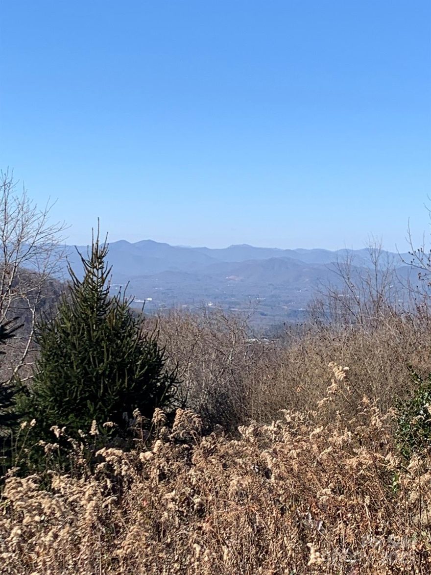 On top of the world and only minutes from downtown Asheville.  This one of kind acreage offers fabulous year round views and privacy for your mountain home.  Gated community. Community well system. Sellers are licensed NC brokers.