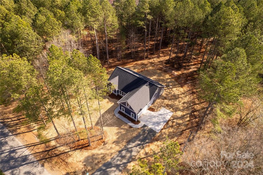 Beautiful new construction home in Marshville on a gorgeous 1 acre lot!  You'll love the elegance and design of this home featuring crown molding in the main living areas and primary bedroom suite.   Fall in love the moment you walk into this bright and open home!  The cook of the home will enjoy the spacious kitchen with a large island perfect for prep work. Tons of windows on the back of the home overlooking the private and spacious yard.  The primary bedroom suite is on the main floor at the back of the home and has both a spacious walk-in closet and spa-like bathroom.  Enjoy two additional bedrooms located on the main floor.  There's an additional bedroom, full bathroom, and bonus room upstairs for guests, hobbies or an additional relaxing/recreational area.   Enjoy your morning coffee on the back patio or relax at the end of a long day.  Closing cost assistance available when using builder's preferred lender.  Come out to see this beauty now!