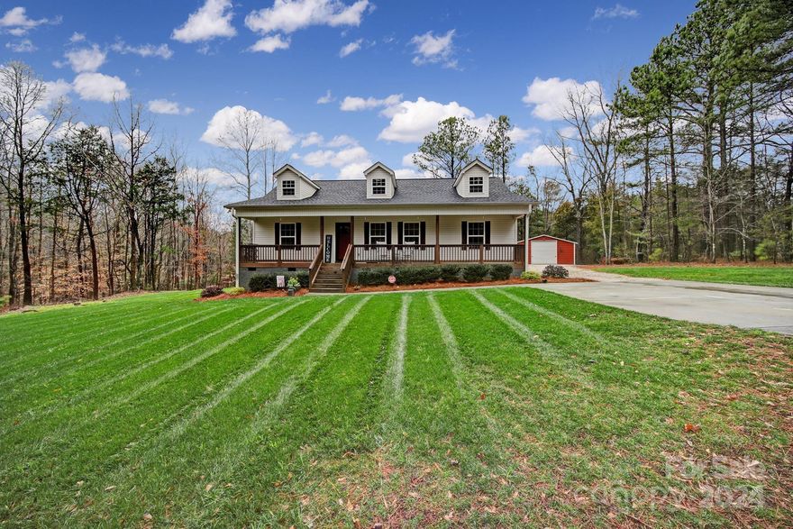 Nestled w/ in private woods, this home offers tranquility & elegance. Set upon 4+ acres of privacy, the property unfolds like a cherished secret waiting to be discovered. Stepping onto the charming front porch, a sense of welcome envelopes you, inviting moments of quiet reflection or lively conversations under the open sky. Inside, the home unfolds with effortless grace, blending modern comforts w timeless charm. The kitchen stands as the heart of the home w granite countertops, the latest appliances & high end cabinetry - a haven for culinary enthusiasts & entertainers alike. Venture further & you'll find the allure of the screened porch an enchanting sanctuary where nature & comfort come together. Whether it's savoring morning coffee on the front porch, watching the seasons change from the screened porch or embarking on walks in your private woods, this home offers a life of boundless opportunity. The detached garage is 720 square feet of storage / workshop / man cave. DO NOT WAIT!!