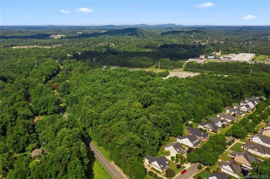 LOCATION! ACREAGE! BELMONT!  NONE other like it....This is THE chance to build an estate on this 3.48 estate lot, just outside of the desirable town of Belmont with sidewalk proximity approximately 200 feet away.  Enjoy all the conveniences of Belmont including parks, Riverfront Park, restaurants, airport and uptown Charlotte.  Perfect place to build your dream home nestled among the trees or clear it, if desired.  In the photos you will see Charlotte over the horizon and streetscape of Belmont downtown.  Buyer and buyer's agent to explore the process and verify.