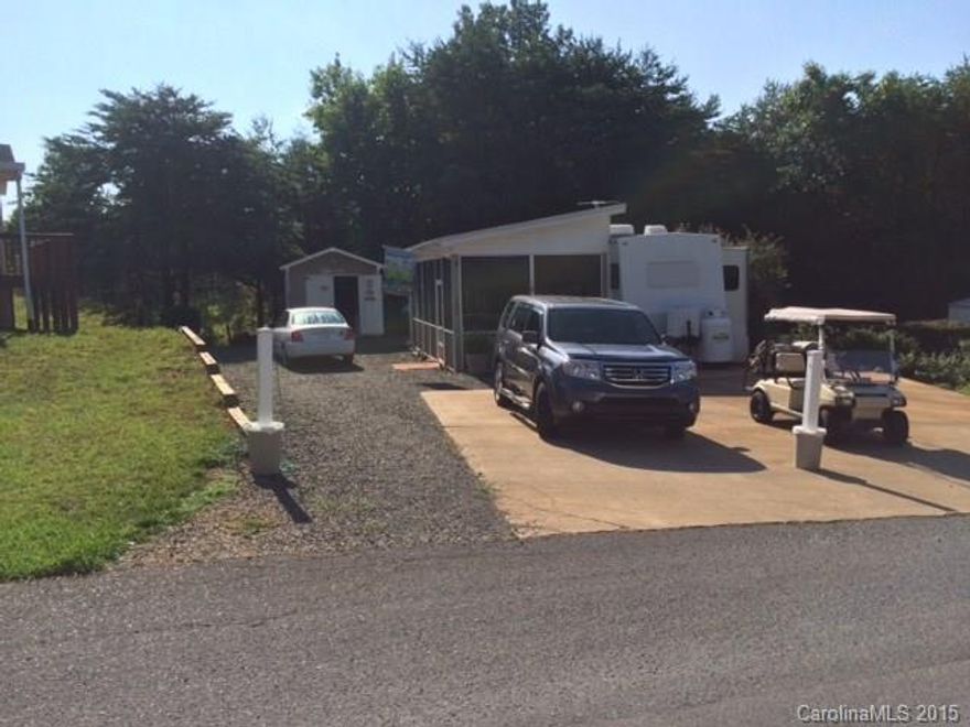 Beautiful 2002 Keystone /Montana RV with 2 slides and  12x29 screened porch with blinds. 10x12 wired storage building (frig. in storage bldg.-remains). RV and parking on concrete pad. Private, nice large lot. Lots of space. New roof air 2011, Built in surround sound. New kitchen faucets, Red Oak cabinets. Great Outdoors! Fire pit, sitting area-GREAT gathering area with landscape lighting on timer.