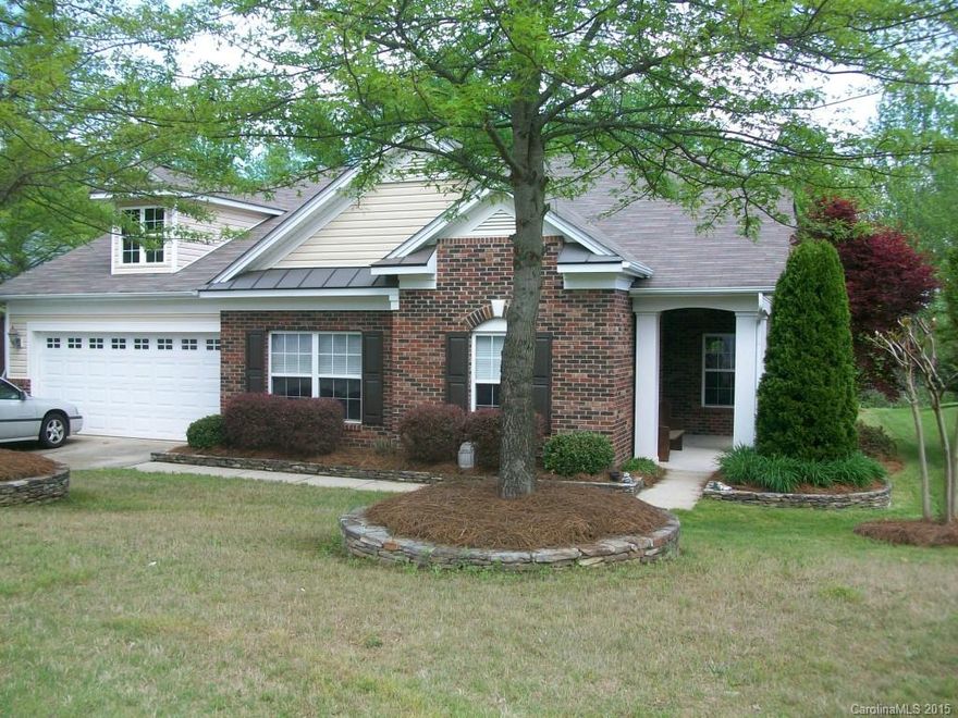 Soaring ceilings, neutral décor with some accent color, beautiful ceramic tile floors except bedrooms with carpet. 2 bedroom split plan (2 bedrooms in front of house and two bedrooms in back of house.  Quiet, peaceful setting in back yard....no neighbors, just wonderful trees extending to the golf course.  Great Commuting to I-77 and Fort Mill Springfield Parkway.  10 Minutes to Carolina Place Mall, 10 minutes to Carrowinds and Cabela's.  Local dining close by.