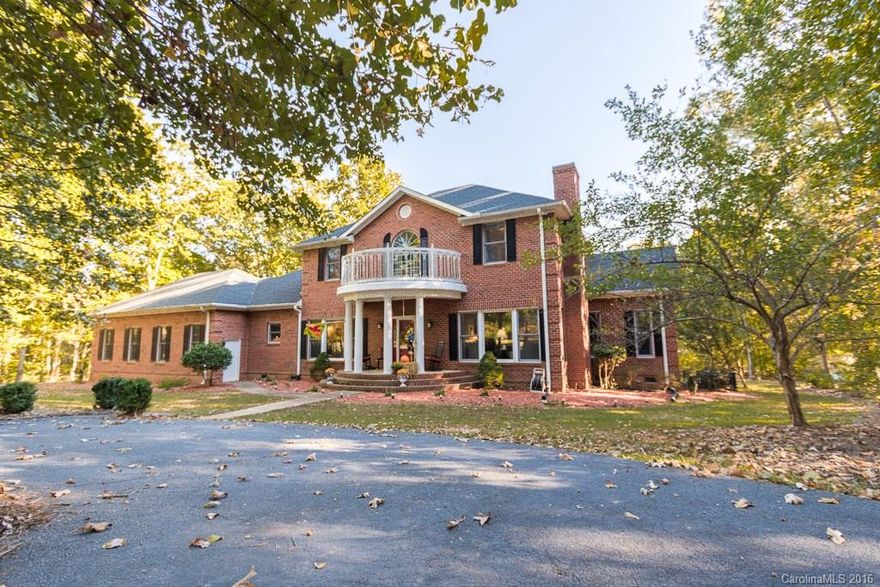 Stunning custom brick home on private 3.61 acres. Features include wide plank hand scraped bamboo flooring, corian counters, pro double ovens, smooth cooktop, tile, heavy molding, 1st floor master,custom cabinets & built-ins, walk-in pantry, walk-in master closet with built-in cabinets & shoe racks, 2-story Greatroom & foryer.  Additional exterior features include 15x30 finished workshop, screened porch, expansive deck, 15x30 in ground salt water pool, outdoor kitchen & full irrigation