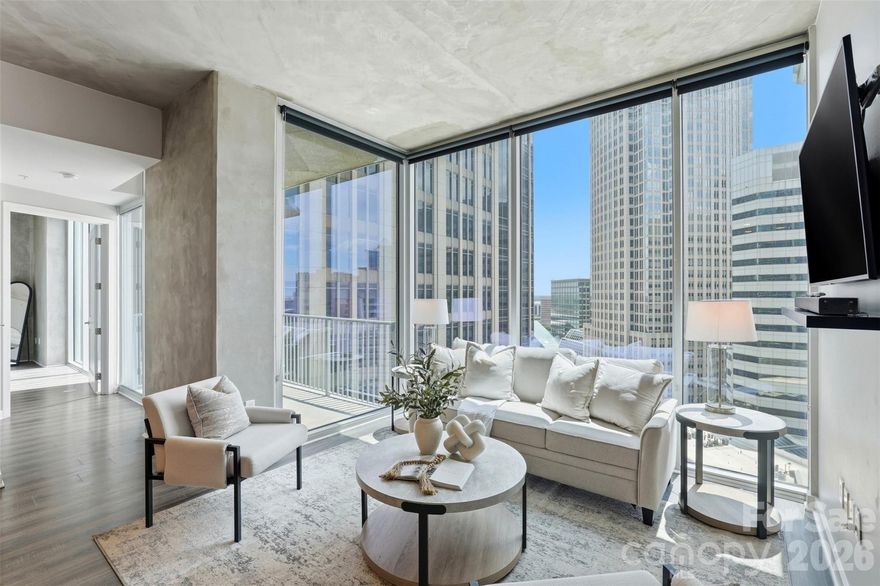 Uptown Living At Its Best! This 18th floor unit at Avenue Condominiums offers an elevated urban living experience in the heart of Uptown Charlotte. This condo is thoughtfully designed from top to bottom with a clean, modern aesthetic and expansive floor-to-ceiling windows that provide sweeping panoramic skyline views and abundant natural light. The open-concept living and dining areas are ideal for entertaining, complemented by a private, tucked-in balcony positioned for vibrant city sunsets. The primary suite serves as a serene retreat with a custom closet, an ensuite bath, and spectacular views of the Charlotte skyline. Additionally, a flexible second bedroom can easily serve as a guest suite or home office. Key features include: Two designated parking spaces on P3 (561 and 562); Google Fiber included in HOA dues; and Incredible Building Amenities: 24-hour concierge in stunning lobby, resort-style pool, fitness center, SkyLounge, business center and more.
