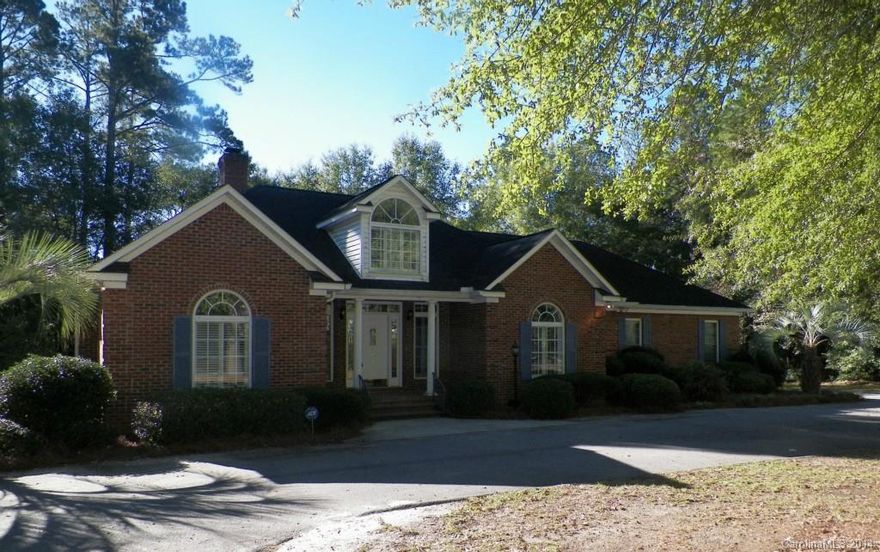 Attractive home on large corner lot with concrete DW leading to side entrance two car garage and det. shop or front entrance.  The rear deck invites you into the sunroom leading to the living area that features a vaulted ceiling and FP.  The kitchen/bkfst with new ceramic tile opens into dining room and is adjacent to the utility with work sink & half bath. Staircase leading to storage over 2 car garage.  Split floor plan gives privacy to MBed&MBath. New carpet in all bedrooms and fresh paint!